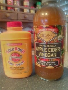 two bottles of apple cider vinegar sitting on a counter