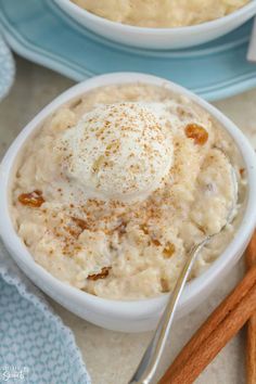 two bowls filled with oatmeal and cinnamon sticks