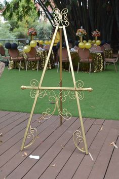 an easel on the ground in front of tables and chairs