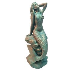 a statue of a mermaid sitting on top of a rock with her hands behind her head