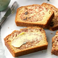 four slices of banana bread with butter on top