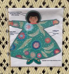 an image of a child's dress on a piece of fabric with words and pictures