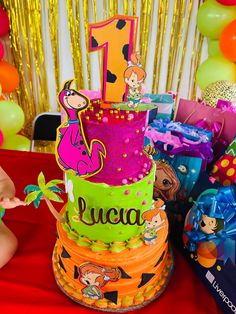 a colorful birthday cake sitting on top of a table