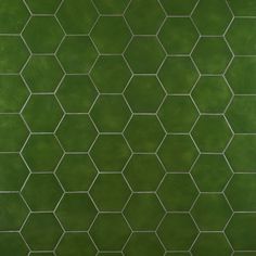 a green tiled wall with hexagonal tiles