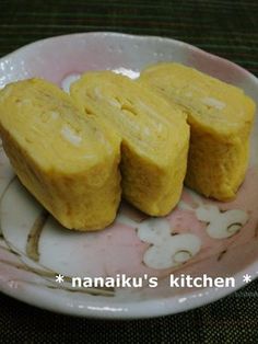 three pieces of food on a plate with writing in the middle that says nanaku's kitchen