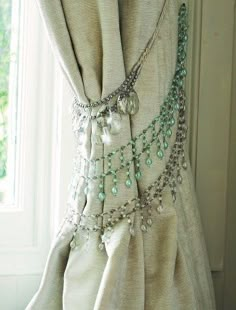 the curtains are covered with beads and chains