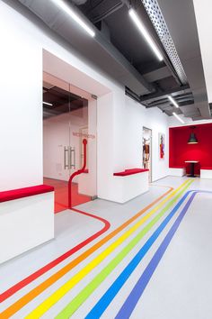 an empty room with rainbow painted floors and white walls