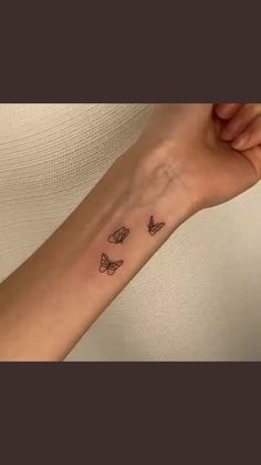 a woman's arm with butterflies tattoo on the left side of her forearm and wrist