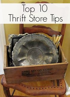 a wooden chair with an old metal pan in it's back pocket on the floor