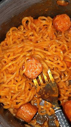 a fork and some noodles in a pot