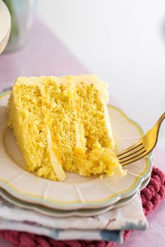 a piece of yellow cake on a plate with a fork