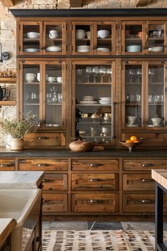 a kitchen with wooden cabinets and glass doors