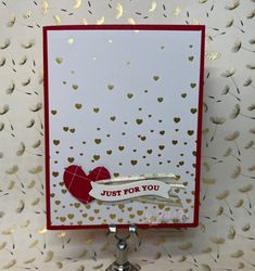 a close up of a greeting card on a metal stand with gold confetti