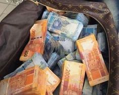 an open suitcase filled with lots of money