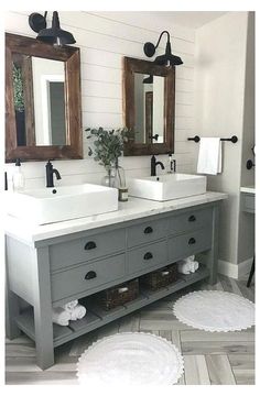 a bathroom with two sinks, mirrors and rugs on the floor in front of them