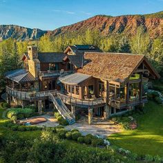 an aerial view of a large home in the mountains