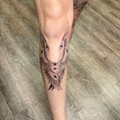 a woman's leg with an eagle tattoo on it