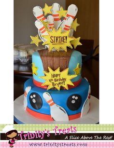 a birthday cake with bowling pins and stars on top that says strike happy birthday to you