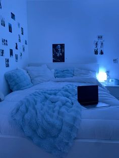 a bed with white sheets and blue lights