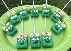 some green treats with googly eyes and marshmallows on sticks in front of them