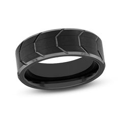 a black ceramic ring with an intricate design