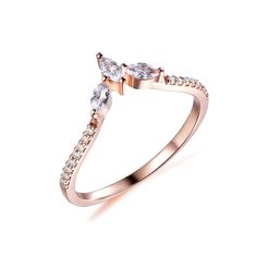 a rose gold ring with two pear shaped diamonds on the side and an open band