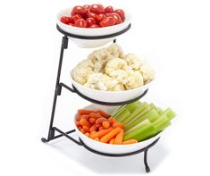 three tiered bowl stand with vegetables and fruits in it on a white background for display