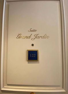 a plaque with the name of grand gardi in gold and blue on it's side