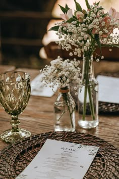 the table is set with flowers and wine glasses