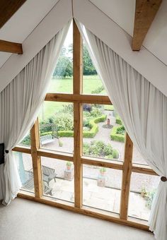 a large open window with curtains on it