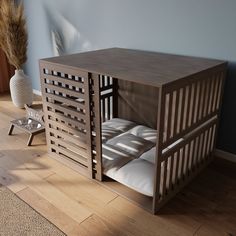 a wooden bed frame with pillows in it on the floor next to a vase filled with flowers