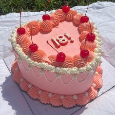 a pink birthday cake with cherries and the number eighteen on it's top