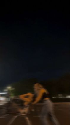 a blurry photo of two people riding bikes at night