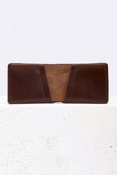 This wallet is made from a single piece of premium full-grain leather from the Horween tannery. There is no lining in this wallet, just beautiful leather and threads. Sized to comfortably hold all currencies in one large pocket for bills. Two separetes card slots for often use. And two compartments for up to 8 cards or small documents and papers. Stitched by hands, edges are polished and painted. Dimensions: 11*8.5*2 cm. (4.3*3.3*0.7 inches) Comes in a black branded gift box. Classic Trifold Wallet With Waxed Finish, Classic Bifold Wallets With Waxed Finish, Brown Vegetable Tanned Leather Wallets For Everyday, Classic Waxed Trifold Wallet, Brown Leather Trifold Wallet With Waxed Finish, Classic Brown Wallet With Waxed Finish, Classic Brown Wallets With Waxed Finish, Classic Handmade Leather Trifold Wallet, Brown Wallet With Coin Pocket In Vegetable Tanned Leather