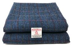 a blue and red plaid wool blanket with a label on the side that says,