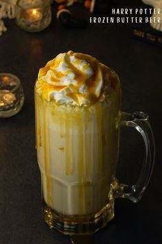 there is a drink with whipped cream on top and caramel drizzle in the bottom