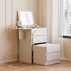 a white desk with drawers and a mirror on it in a room next to a window