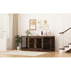 a living room scene with focus on the wooden sideboard and staircase leading up to the second floor