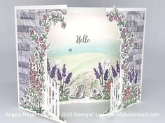 an open card with flowers and vines on it