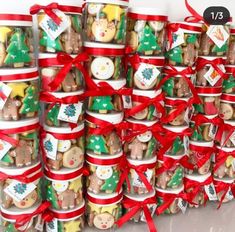 a stack of christmas themed cookies with red ribbon and bows on the top are stacked up