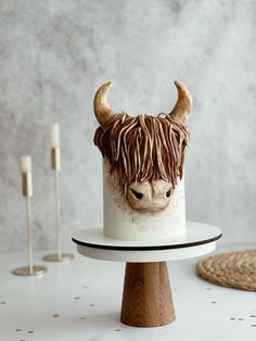 there is a cake decorated to look like a bull's head on a stand