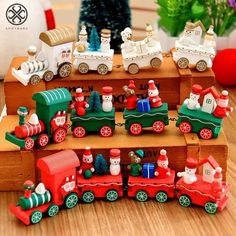 a wooden train set with santa and snowmen on the tracks next to a christmas tree