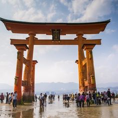 a group of people standing in front of a large wooden structure