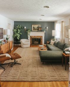 a living room filled with furniture and a fire place in the middle of a room