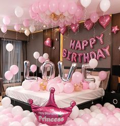 a birthday party with balloons and heliums in the shape of letters, stars, and princess tiara