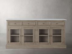 the sideboard is made from wood and has two glass doors, one with marble top