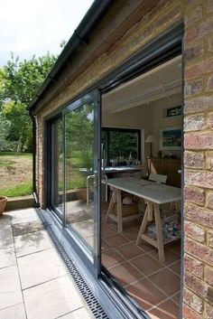 an open patio with sliding glass doors leading to the back yard and dining room area