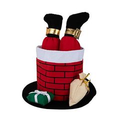 two red wine bottles sitting in a santa's chimney on top of a black hat