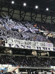 a large banner in the stands at a sporting event with people sitting and standing on the bleachers