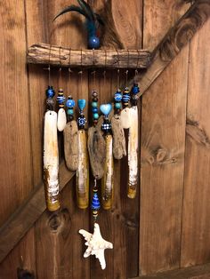 an assortment of bottles hanging from a wooden rack with shells and starfish on it